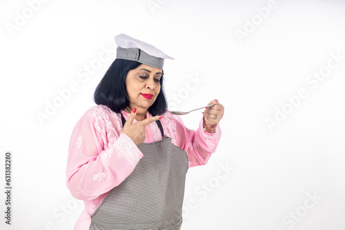Indian female chef testing food on white background.