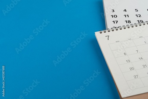 close up of calendar on the blue table background, planning for business meeting or travel planning concept