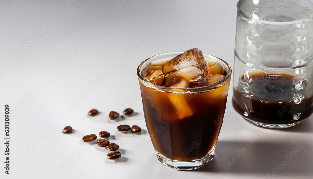 Cold black coffee with ice cubes on a white background. Coldbrew. Summer drinks. Cold black coffee with ice cubes on a white background. Coldbrew. Summer drinks.