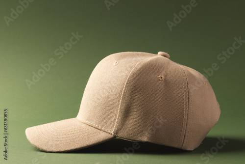Cream baseball cap and copy space on green background