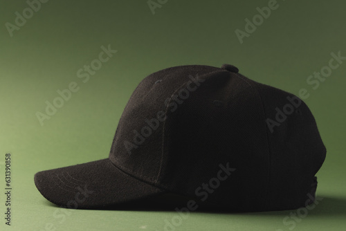 Black baseball cap and copy space on green background