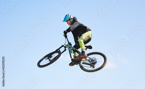 Bicycle, man and jump in blue sky for competition, freedom and adventure with mockup space. Athlete, sports and bike in air for action, cardio race and courage for stunt performance, power or contest