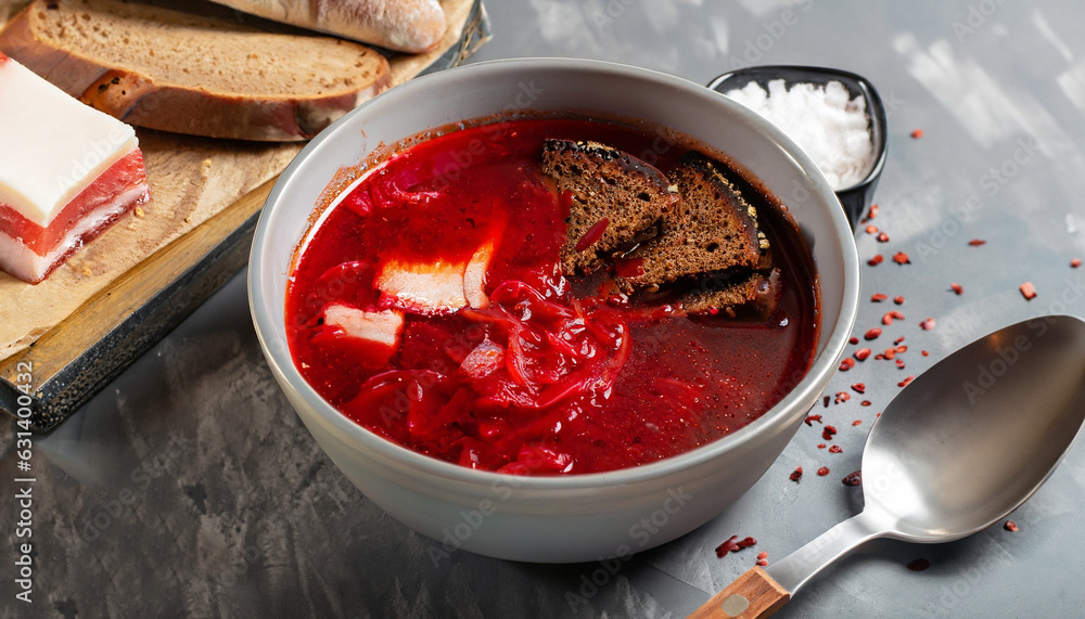 Delicious fresh red borscht, dark bread with lard and salt on kitchen table. Copy space. Delicious fresh red borscht, dark bread with lard and salt on kitchen table. Copy space.