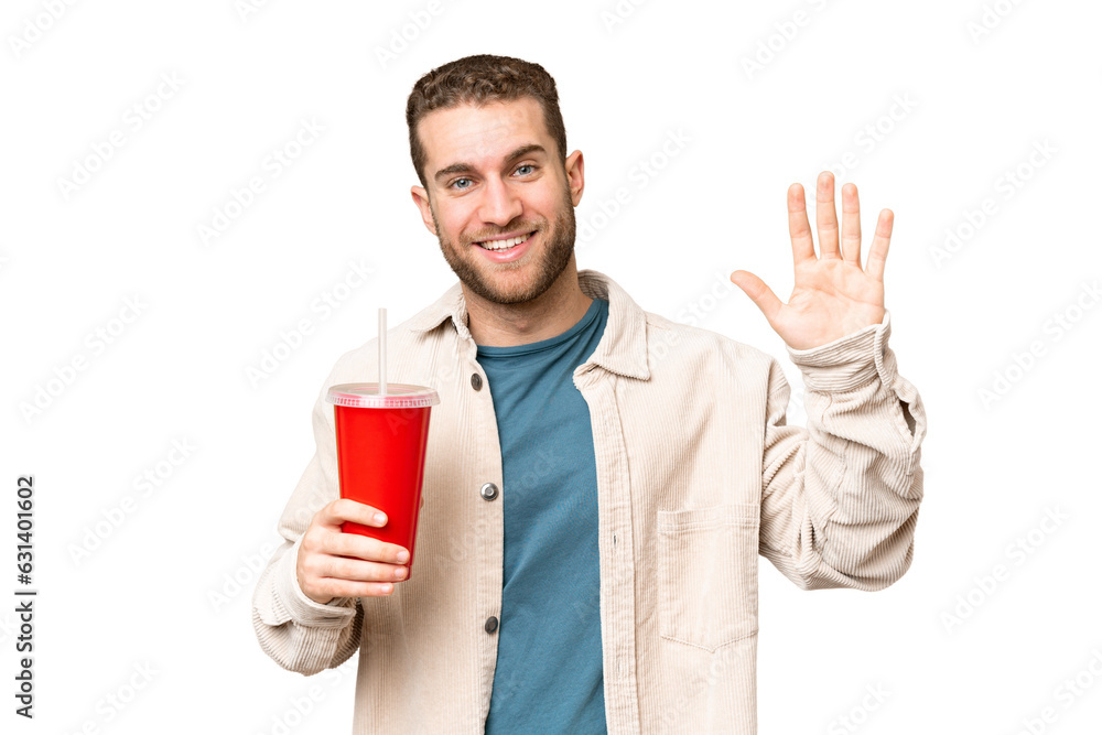 Young handsome blonde man holding soda over isolated chroma key background saluting with hand with happy expression Young handsome blonde man holding soda over isolated chroma key background saluting with hand with happy expression