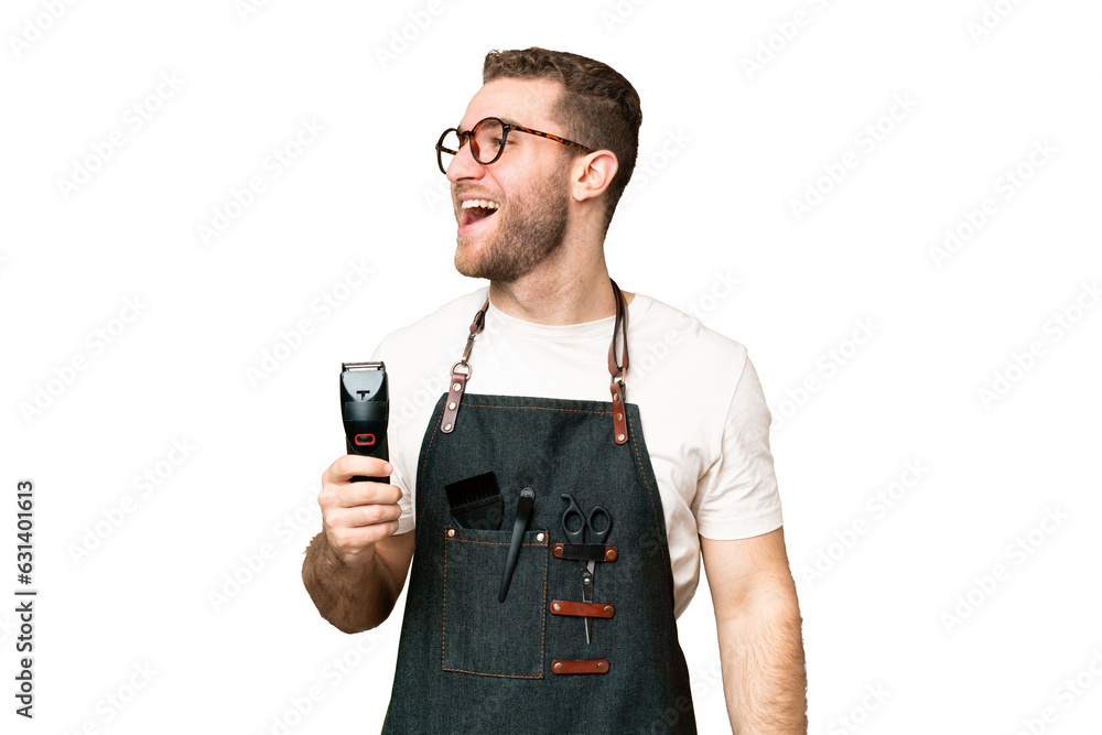 Barber man in an apron over isolated chroma key background laughing in lateral position Barber man in an apron over isolated chroma key background laughing in lateral position