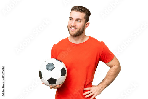 Handsome young football player man over isolated chroma key background posing with arms at hip and smiling