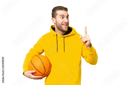 Young handsome blonde man over isolated chroma key background playing basketball and having an idea © luismolinero