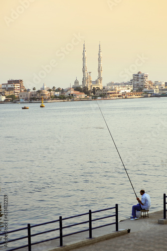 Fényképezés Port Said, man fishing at port