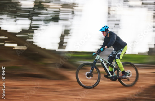 Bike, man and speed with motion blur in forest for sport, race or adventure in summer, woods or nature. Extreme fast cycling, person and action on trail, workout or challenge for fitness with freedom