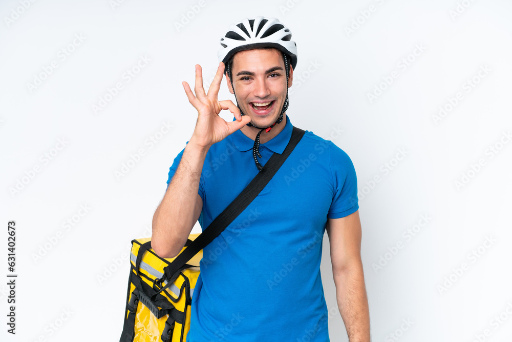 Young caucasian man with thermal backpack isolated on white background showing ok sign with fingers Young caucasian man with thermal backpack isolated on white background showing ok sign with fingers