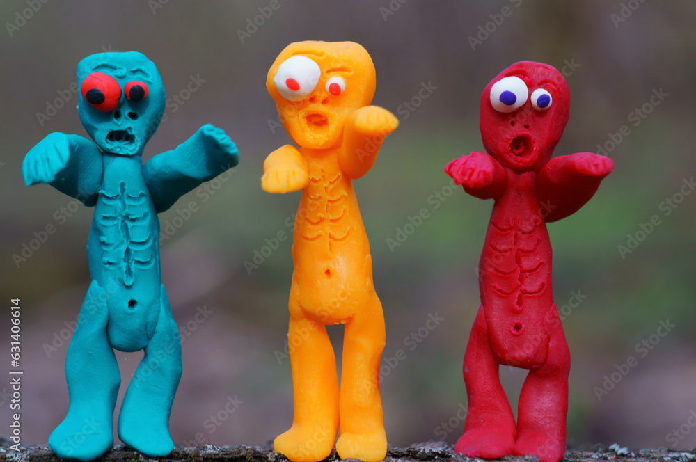 Obraz premium Figures of three funny different zombies. Colorful toys.