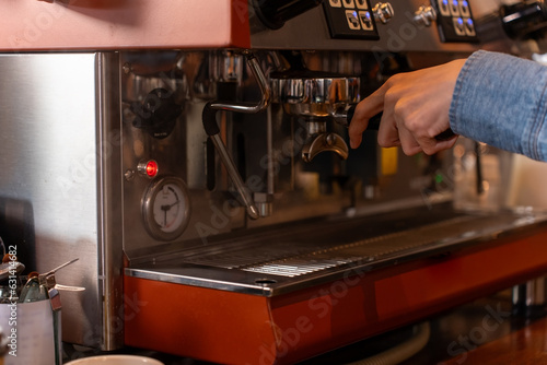 Close up hand of woman making a cup of coffee in her coffee shop. small business, business owner.