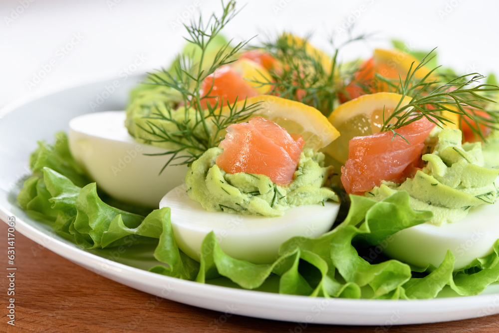 Eggs stuffed with avocado, salmon and lemon. The perfect appetizer for your holiday table. Eggs stuffed with avocado, salmon and lemon. The perfect appetizer for your holiday table.