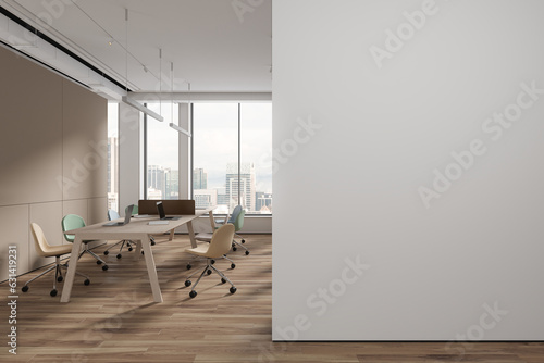 White and beige open space office with blank wall
