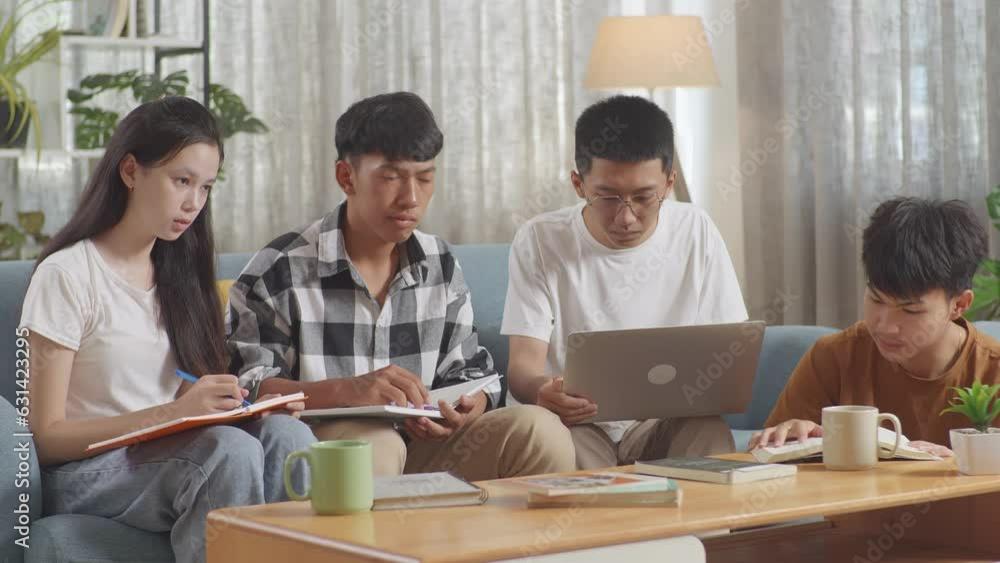 Asian Teen Group Studying At Home. Helping Each Other Doing Project, A Girl Writing Into Notebook, A Boy In Plaid Shirt Thinking, A Boy In White T-Shirt Typing On Laptop Sitting Next To Another Boy Re Asian Teen Group Studying At Home. Helping Each Other Doing Project, A Girl Writing Into Notebook, A Boy In Plaid Shirt Thinking, A Boy In White T-Shirt Typing On Laptop Sitting Next To Another Boy Re