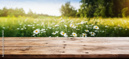 Empty rustic old wooden boards table copy space with chamomile flowers growing on a meadow background. Product display template. Generative AI