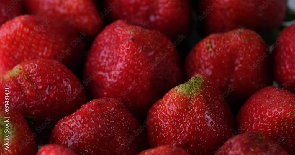 Delicious ripe bright red strawberries lie on white plate rotating. Appetizing fruits with juicy texture and sweetness. Organic fresh harvest Delicious ripe bright red strawberries lie on white plate rotating. Appetizing fruits with juicy texture and sweetness. Organic fresh harvest