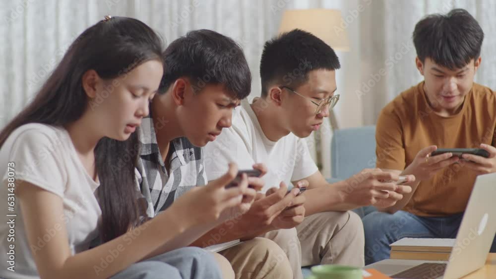 Close Up Of Asian Teen Group Playing Game On Smartphone, Break Time After Working On Online Project, Students With Books And Laptop Studying At Home
Close Up Of Asian Teen Group Playing Game On Smartphone, Break Time After Working On Online Project, Students With Books And Laptop Studying At Home