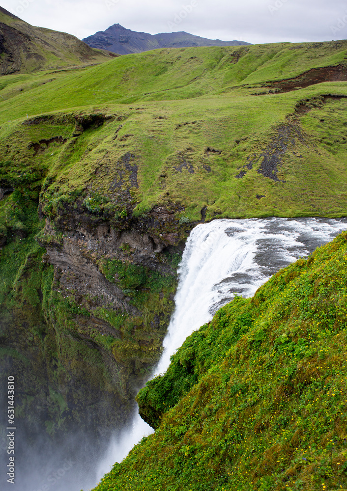 Famous icelandic waterfall Skogafoss in the mountains on Iceland Famous icelandic waterfall Skogafoss in the mountains on Iceland
