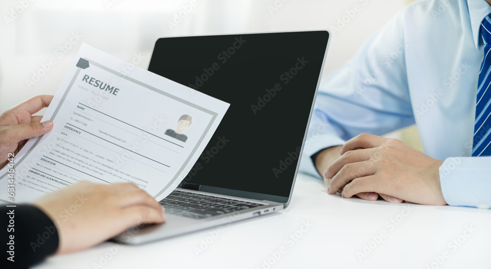 Business people hold a resume and talk to job applicants for job interviews about careers and Their personal history in the company. Employment and Recruitment concepts Business people hold a resume and talk to job applicants for job interviews about careers and Their personal history in the company. Employment and Recruitment concepts