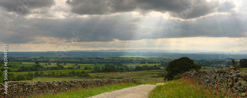 Panoramic view of Sun Rays poking through clouds near Appleby, North Pennines, England, UK.