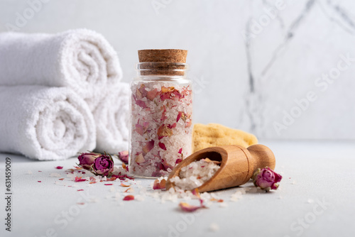 Still life with homemade roses bath salt, white towels and natural sea sponge
