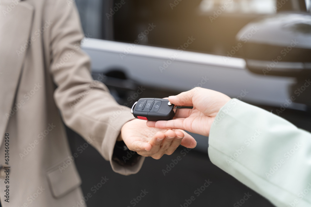transportation rental automotive business concept. Close up hands of rental auto agent giving car remote key to client to travel sightseeing. transportation rental automotive business concept. Close up hands of rental auto agent giving car remote key to client to travel sightseeing.