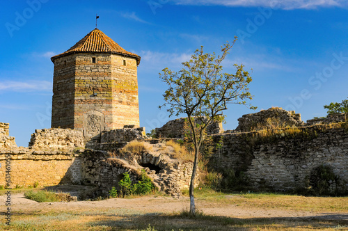 Corner tower witht tiled roof and ruins of walls of medieval Akkerman Fortress in Bilhorod-Dnistrovskyi, Odesa region, Ukraine photo