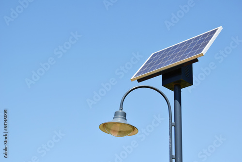 Street lamp with a solar panel on a sunny day