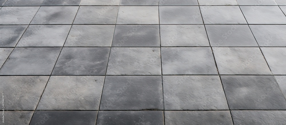 Rows and lines of square sidewalk tiles in a gray color are found on floors either outside or Rows and lines of square sidewalk tiles in a gray color are found on floors either outside or