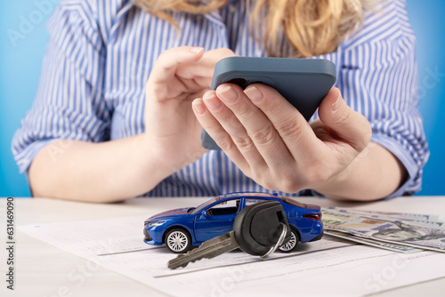 online car buying, woman buys a vehicle through the phone on the site, buying and selling new and used cars by internet
