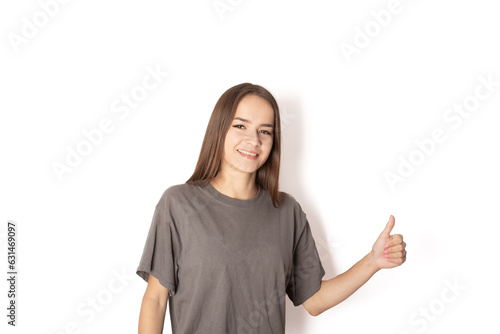 Wallpaper Mural positive teenager showing thumb up in approval, recommending, like, young woman student on white background, Torontodigital.ca
