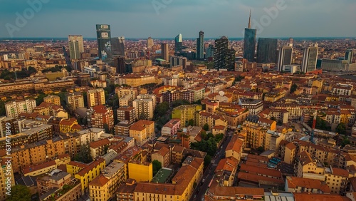 milan city aerial view drone of business district porta nuova at sunrise,skyscrapers with mountain in the background