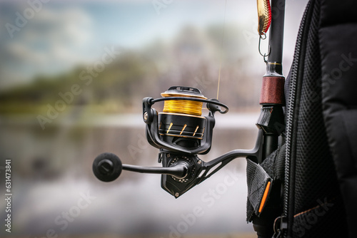Fishing  reel and compact rod. Fishing tackle background.  © vitaliy_melnik