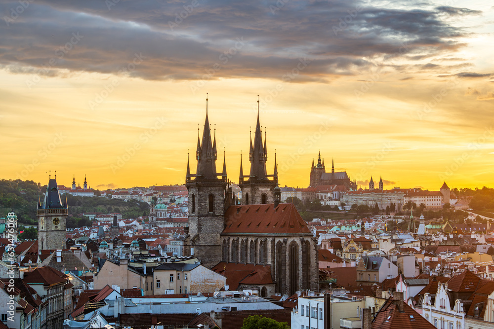 The cityscape of Prague and the Church of Our Lady before Tyn and Prague castle in a summer sunset.
