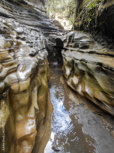 Trekking is dangerous and risky from flash floods in rocky canyon at Hells Gate National Park in portrait view in Naivasha - Kenya