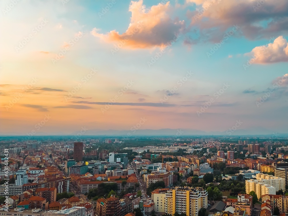 Fototapeta premium Skyline of a big city with beautiful clouds at sunset. Business and finance concept. Milan, Italy