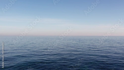 Calm Morning Ocean Flight - Low-Flying Drone Footage of Horizon at Sunrise, Serene Ocean Surface, and Sky - 4K Aerial Cinematic Landscape