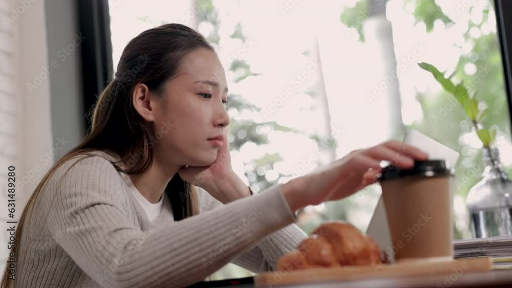 4k, Asian business owner female thoughtful looking business performance in laptop and worried turnover profit, freelancer or employee holding hot coffee concentrated with stack of paperwork invoice 4k, Asian business owner female thoughtful looking business performance in laptop and worried turnover profit, freelancer or employee holding hot coffee concentrated with stack of paperwork invoice
