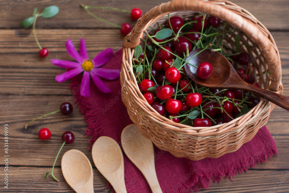 Ripe cherry berries in a bowl on the table with wooden spoons. Jam recipe Ripe cherry berries in a bowl on the table with wooden spoons. Jam recipe
