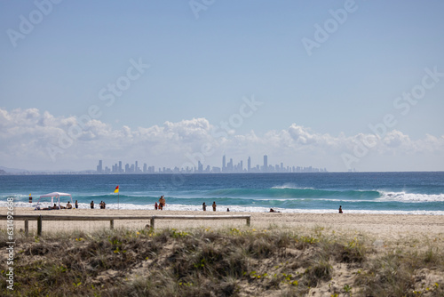 Tourists on Coolangatta beach along the Gold Coast  with skyline in background in Queensland  Australia