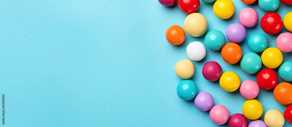 Colorful candy balls are displayed on a blue paper background in the format of a horizontal