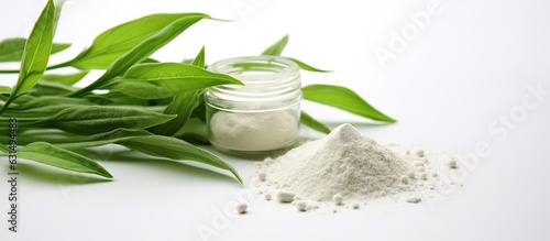 Close Up of Andrographis Paniculata Powder and Herbal Capsules on a White Background. copy space