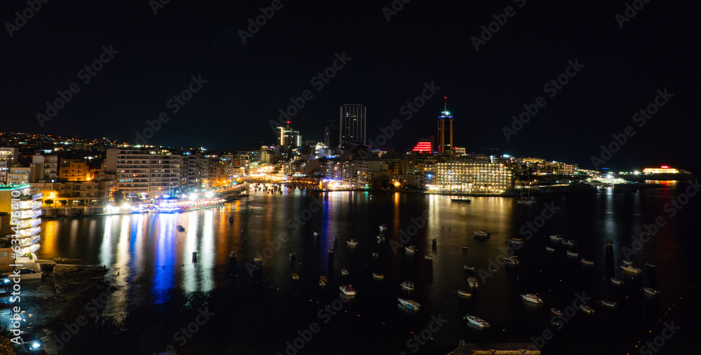view of St. Julian's bay at night from Sliema in Malta