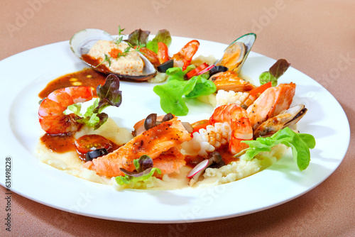 delicious grilled fresh seafood platter muscle, fish, prawn w mash potato and mushroom vegetable in white plate on brown background premium western cafe halal food menu for restaurant