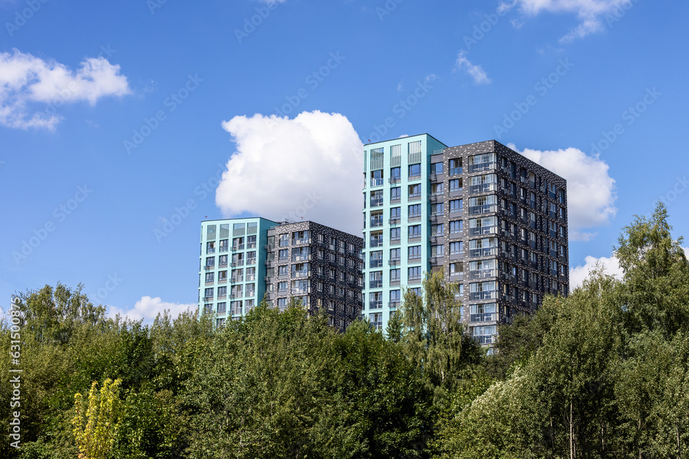 Residential apartment buildings surrounded by green trees 