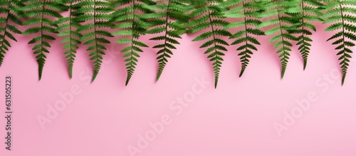 Green fern leaves that are crocheted can be seen on a pink background, providing a lovely summer-themed