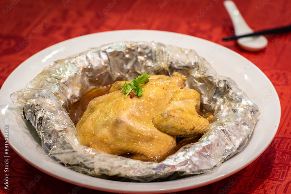 traditional asian double boiled herbal whole chicken meat soup wrap in aluminium foil on red table chinese new year cuisine halal food restaurant banquet menu traditional asian double boiled herbal whole chicken meat soup wrap in aluminium foil on red table chinese new year cuisine halal food restaurant banquet menu