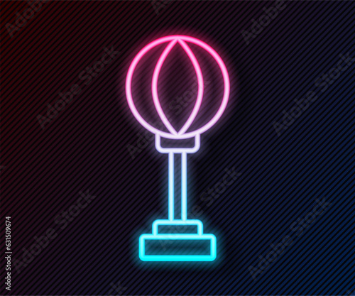 Glowing neon line Punching bag icon isolated on black background. Vector