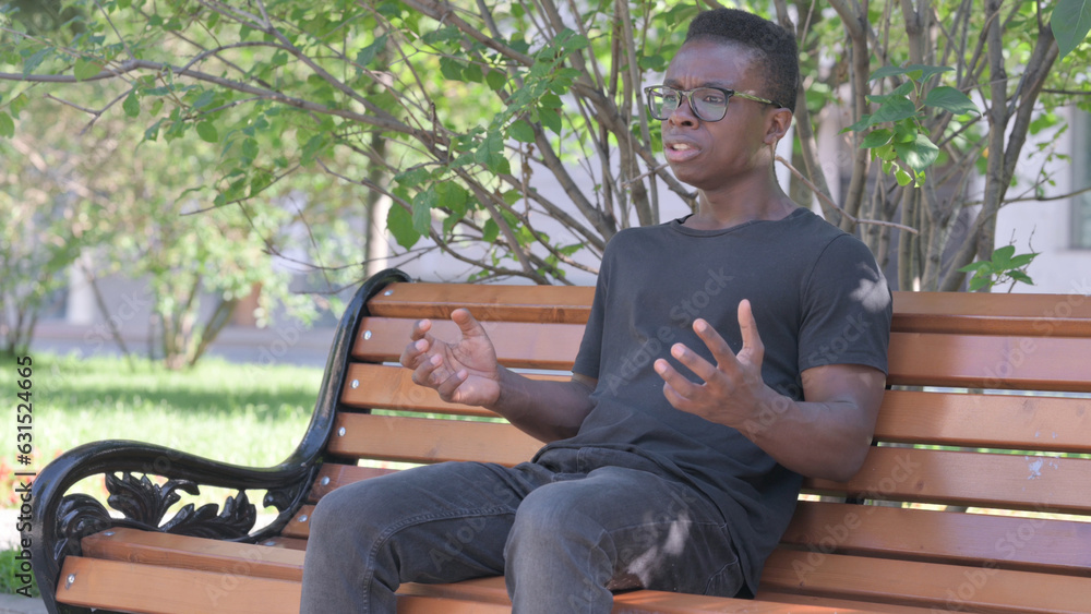 Obraz premium Worried Young African Man Sitting Outdoor Feeling Scared and Afraid